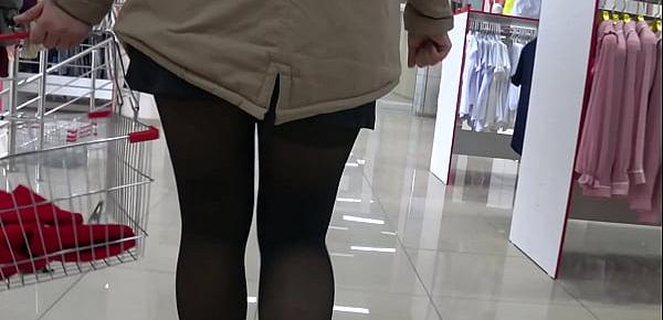  Voyeur peeks under her skirt in public. And with a hidden camera in a fitting room spies on a girl with a juicy ass in nylon tights. Foot fetish.